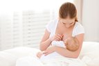 Lesbian couple take turns breastfeeding their baby